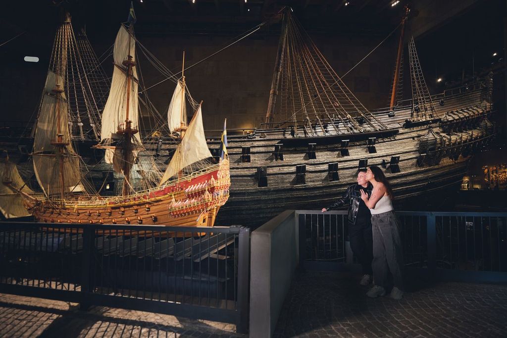 Två kvinnor håller om varandra framför skeppet Vasa och en modell av skeppet.